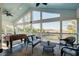 Screened-in porch with comfortable seating and foosball table, offering a serene outdoor living space at 2101 Guerins Bridge Rd, Wando, SC 29492