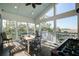 Inviting screened porch with a dining table and foosball, ideal for outdoor dining and entertainment at 2101 Guerins Bridge Rd, Wando, SC 29492