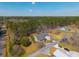 Drone shot of home with covered front porch and long driveway nestled among trees at 2101 Heavens Way, Summerville, SC 29483