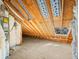 Spacious unfinished attic with exposed wooden beams, insulation, and a small window at 2101 Heavens Way, Summerville, SC 29483