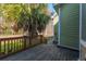 Wooden back deck features a wooden railing overlooking a yard with trees and a side patio at 2101 Heavens Way, Summerville, SC 29483