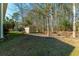 Outdoor shed in a fenced yard with lush green grass and mature trees at 2101 Heavens Way, Summerville, SC 29483