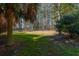 Large fenced-in backyard featuring a lush green lawn and mature trees, perfect for outdoor activities at 2101 Heavens Way, Summerville, SC 29483
