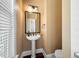 Charming powder room with pedestal sink, framed mirror, and warm wall color, creating a cozy space at 2101 Heavens Way, Summerville, SC 29483