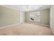 Neutral bedroom with carpet, large window providing natural light, and white trim at 2101 Heavens Way, Summerville, SC 29483