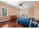 Bedroom with wood floors, ceiling fan, bright windows, and access to balcony at 2101 Heavens Way, Summerville, SC 29483