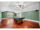 Spacious game room featuring a pool table, hardwood floors, and natural light from a large window at 2101 Heavens Way, Summerville, SC 29483