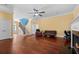 Bright living room with a fireplace, ceiling fan, hardwood floors, and staircase at 2101 Heavens Way, Summerville, SC 29483