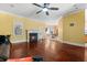 Open living room with ceiling fan, fireplace, hardwood floors and view of breakfast nook at 2101 Heavens Way, Summerville, SC 29483