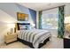Modern bedroom showcasing the blue accent wall and light wood nightstand with stylish lamp at 2210 Norwood Oaks Dr, Mount Pleasant, SC 29466