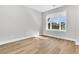 Bright bedroom with wood floors and a window offering a view of the trees outside at 2210 Norwood Oaks Dr, Mount Pleasant, SC 29466