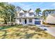 Charming two-story home with a well-manicured lawn and a gray two car garage on the right at 2210 Norwood Oaks Dr, Mount Pleasant, SC 29466