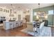 Elegant kitchen with white cabinets, a large island, stainless steel appliances, and a dining area at 2210 Norwood Oaks Dr, Mount Pleasant, SC 29466