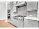 Updated kitchen showcasing stainless steel KitchenAid range, gray cabinetry, and tile backsplash at 2210 Norwood Oaks Dr, Mount Pleasant, SC 29466