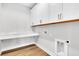 Bright laundry room featuring white cabinets, quartz countertop, and wood-look flooring at 2210 Norwood Oaks Dr, Mount Pleasant, SC 29466