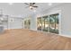 Open floor plan of the living room with multiple sliding glass doors and wood flooring at 2210 Norwood Oaks Dr, Mount Pleasant, SC 29466