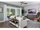 Cozy living room with modern decor, a ceiling fan, and large windows providing natural light at 2210 Norwood Oaks Dr, Mount Pleasant, SC 29466