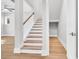 Bright staircase with white railings and hardwood steps, complemented by neutral walls and flooring at 2210 Norwood Oaks Dr, Mount Pleasant, SC 29466