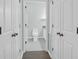 Bathroom view from hallway featuring white doors, toilet, and vanity at 2212 Telfair Way, Charleston, SC 29412