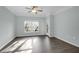 Bright bedroom featuring a window and glass exterior door with wood-look floors at 2212 Telfair Way, Charleston, SC 29412