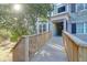 Charming condo exterior with a wooden ramp leading to the entrance and lush greenery at 2212 Telfair Way, Charleston, SC 29412