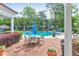 Refreshing swimming pool area with lounge chairs, lush landscaping, and shade umbrellas at 2212 Telfair Way, Charleston, SC 29412