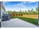 Serene backyard featuring a lush green lawn, a privacy fence, and a covered grill at 242 Bering Ln, Summerville, SC 29486