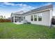 Well-maintained backyard with lush green grass, a screened porch, and a grill under a cover at 242 Bering Ln, Summerville, SC 29486