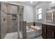 Tiled bathroom with walk in shower, soaking tub, and granite countertops at 242 Bering Ln, Summerville, SC 29486