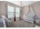 Charming Bedroom with a crib, glider, and soft, soothing colors at 242 Bering Ln, Summerville, SC 29486