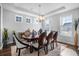 Elegant dining room featuring large windows, a modern chandelier, and an ornate table set for six at 242 Bering Ln, Summerville, SC 29486