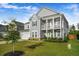 Charming two-story home with a double porch and manicured lawn at 242 Bering Ln, Summerville, SC 29486