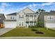 Attractive two-story home with a welcoming porch, blue door, and well-kept lawn at 242 Bering Ln, Summerville, SC 29486