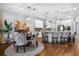 Open kitchen with a granite island, stainless steel appliances and chairs around a breakfast table at 242 Bering Ln, Summerville, SC 29486