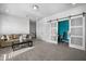 Spacious living room with neutral colors and a sliding door to an office at 242 Bering Ln, Summerville, SC 29486