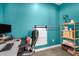 Bright office features an accent wall, a contemporary desk, and a sliding barn door at 242 Bering Ln, Summerville, SC 29486