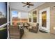 Comfortable screened porch features a ceiling fan and outdoor seating, perfect for relaxation at 242 Bering Ln, Summerville, SC 29486