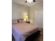 A bedroom featuring a plush bed, matching nightstand with lamp, and a closet for ample storage at 2598 Spivey Ct, North Charleston, SC 29406