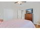 A cozy bedroom with hardwood floors, ceiling fan, dresser, and natural light at 2598 Spivey Ct, North Charleston, SC 29406