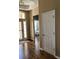 View of the entryway with hardwood floors, a decorative light fixture, and an open view of the bedroom at 2598 Spivey Ct, North Charleston, SC 29406