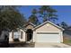 Charming single-Gathering home with a manicured lawn, attached garage, and a welcoming front entrance at 2598 Spivey Ct, North Charleston, SC 29406