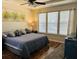 Serene main bedroom featuring a ceiling fan, hardwood floors, and natural light from the windows at 2598 Spivey Ct, North Charleston, SC 29406
