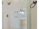 Modern bathroom shower with marble tiling, built-in shelving and glass door at 2598 Spivey Ct, North Charleston, SC 29406