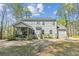 Back exterior of home with screened porch and lush green yard at 3000 Flat Rock Ln, Ridgeville, SC 29472