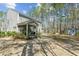 Back exterior of home with screened porch and spacious wooded backyard at 3000 Flat Rock Ln, Ridgeville, SC 29472