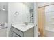 Bathroom featuring a sink with gray cabinets, large mirror, and a shower with curtain at 3000 Flat Rock Ln, Ridgeville, SC 29472