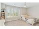 Cozy bedroom featuring a ceiling fan, gray carpet, and bright window with plantation shutters at 3000 Flat Rock Ln, Ridgeville, SC 29472
