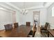 Open-concept dining room featuring decorative chandelier, hardwood floors, and elegant wainscoting at 3000 Flat Rock Ln, Ridgeville, SC 29472