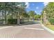 Community entrance with brick pillars, iron gates, and paved road at 3000 Flat Rock Ln, Ridgeville, SC 29472