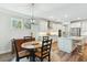 Bright kitchen with stainless steel appliances, white cabinets, island with countertop seating and breakfast nook at 3000 Flat Rock Ln, Ridgeville, SC 29472